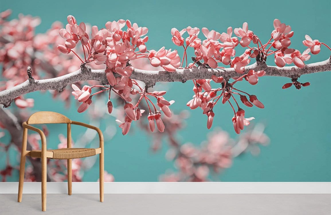 Tranquil teal floral wallpaper with pink blossoms, wooden chair, grey flooring in modern interior.