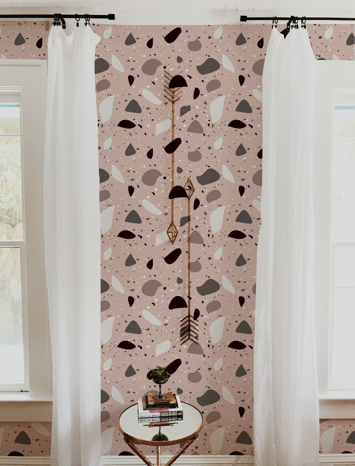 Abstract geometric blush and grey wallpaper with white curtains and decorative arrows in living room.