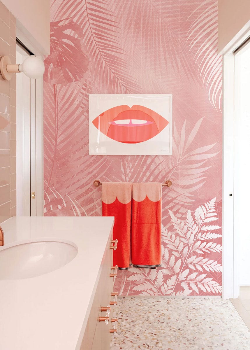 Blush Pink Tropical Foliage Wallpaper in modern bathroom with terrazzo flooring and stylish art piece.