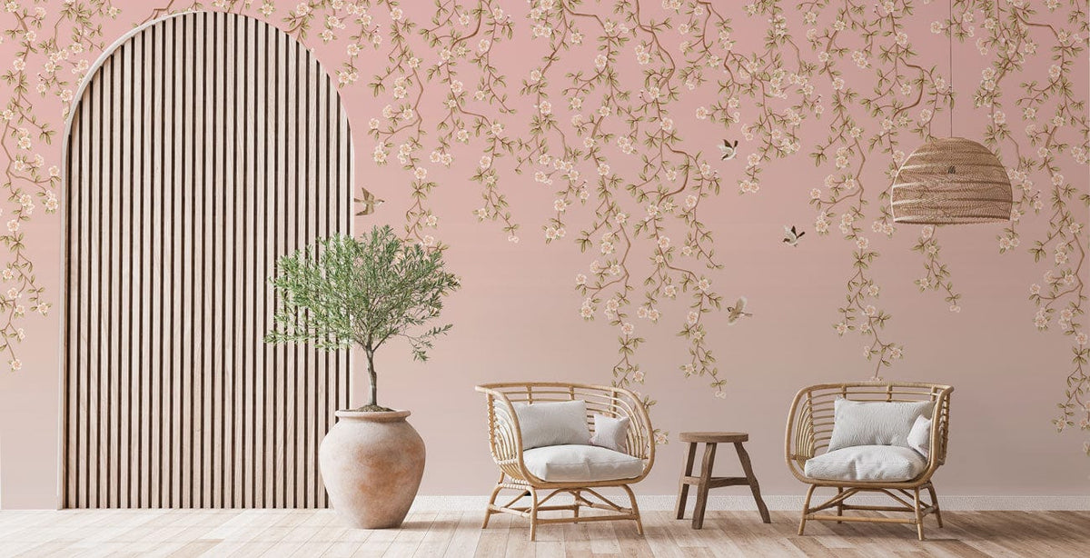 Blossoming pink floral mural wallpaper, rattan chairs, wooden flooring, large vase, pendant light, lounge room.