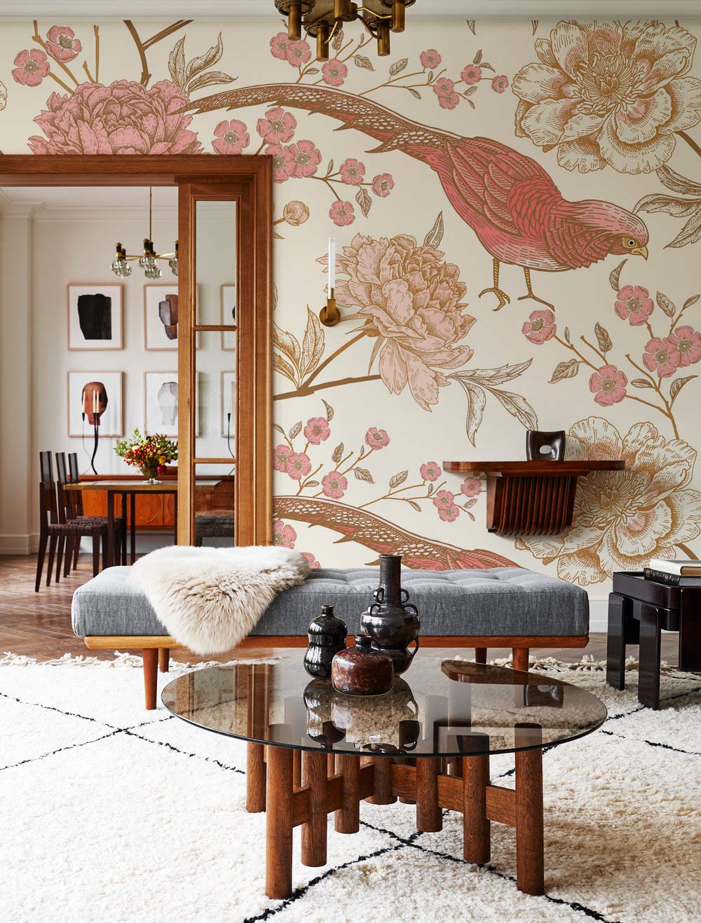 Elegant vintage pink floral bird wallpaper, grey bench, wooden coffee table in stylish living room setting.