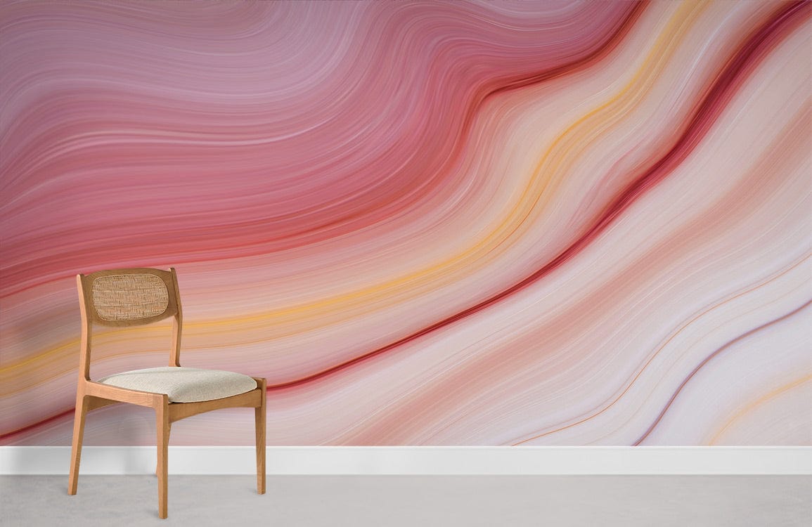 Abstract mural with pink and yellow waves, featuring a minimalist wooden chair on grey flooring.
