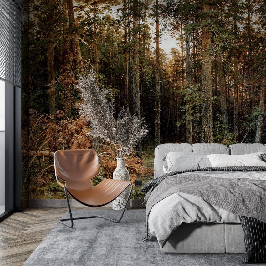 Enchanted Forest mural with earthy tones, grey bed, modern brown chair, grey rug, wooden floor.