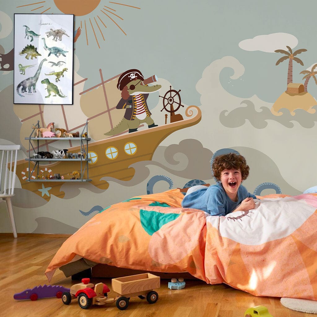 Playful Pirate Adventure Mural Wallpaper for children's room, nautical theme; bed, colourful decor, wooden flooring.