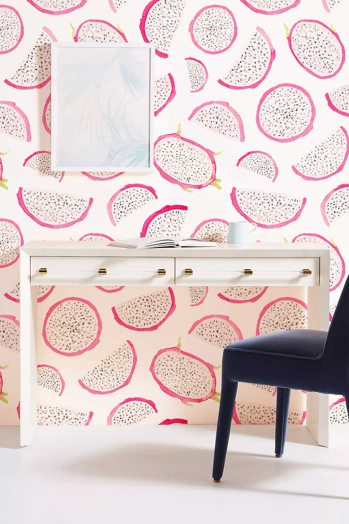Vibrant dragon fruit wallpaper mural with white desk, navy blue chair, bright room setting.