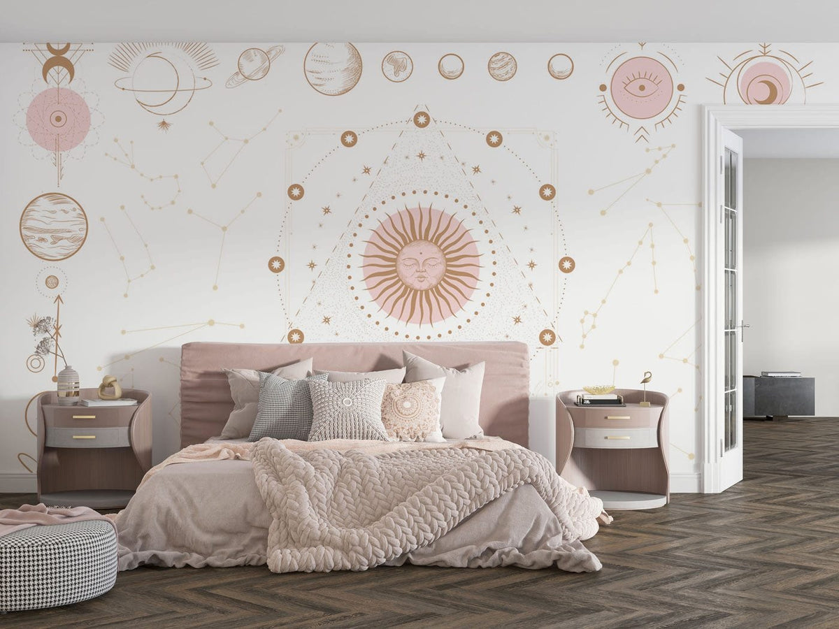 Bohemian bedroom with pink beige cosmic mural wallpaper, cosy bed, side tables, and herringbone wood flooring.