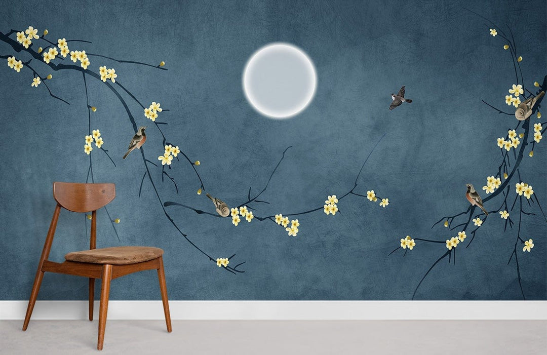 Mystical Night Sky Blue Mural Wallpaper, moon and blossoms design, wooden chair, concrete flooring.