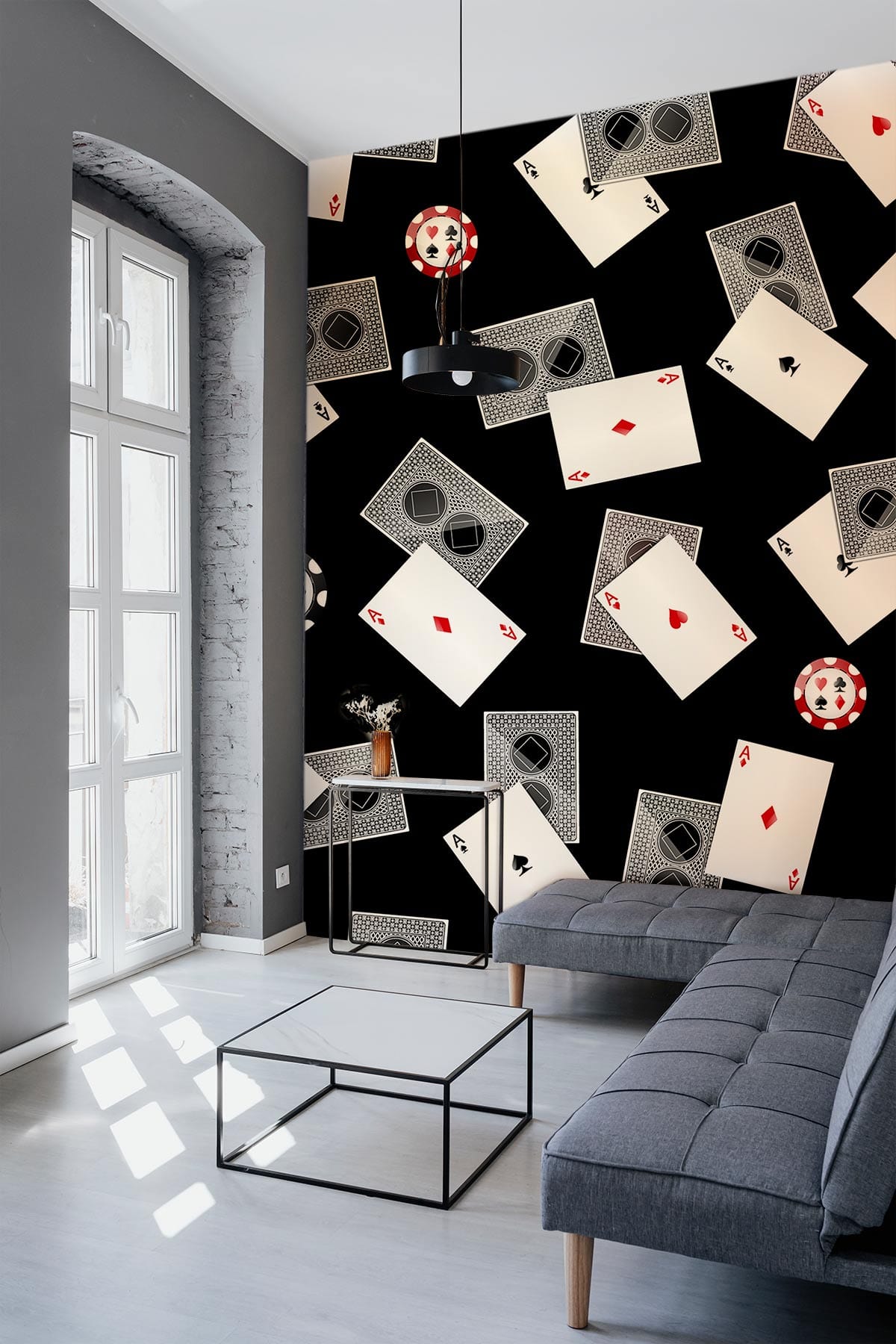 Chic wallpaper with cards and chips, grey modern sofa, stylish decor in contemporary living room.