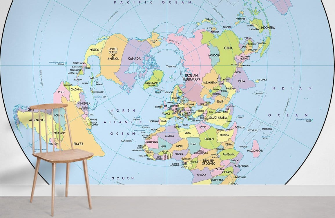 Colourful World Map Mural Wallpaper in room with wooden chair, grey floor, white wall, educational Décor.
