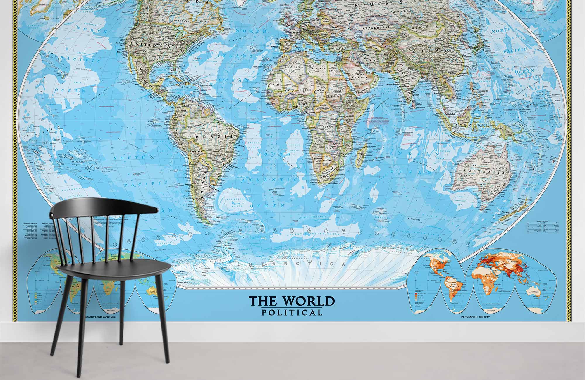 Vintage World Map Mural Wallpaper in blue, with black chair, for educational decor on white wall.