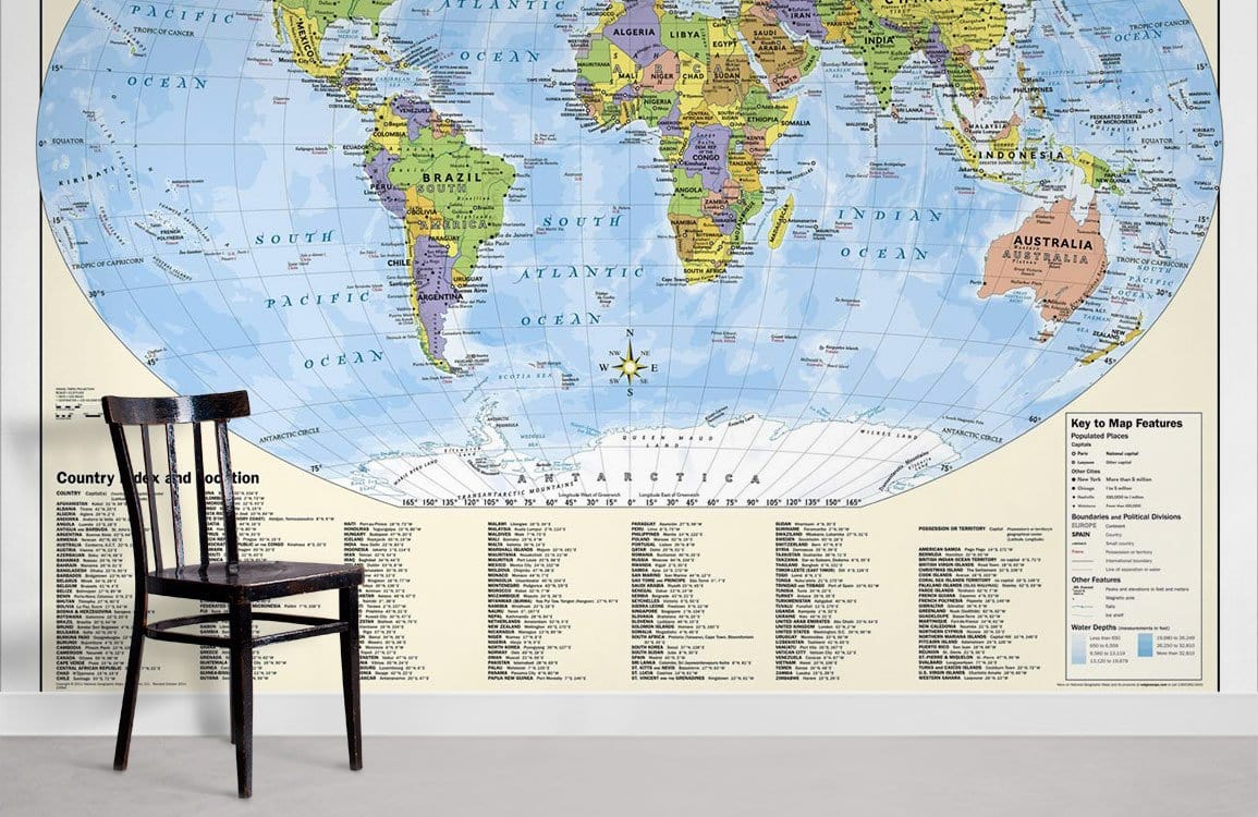 Vintage world map mural wallpaper in study room with a black chair, grey flooring, colourful design.