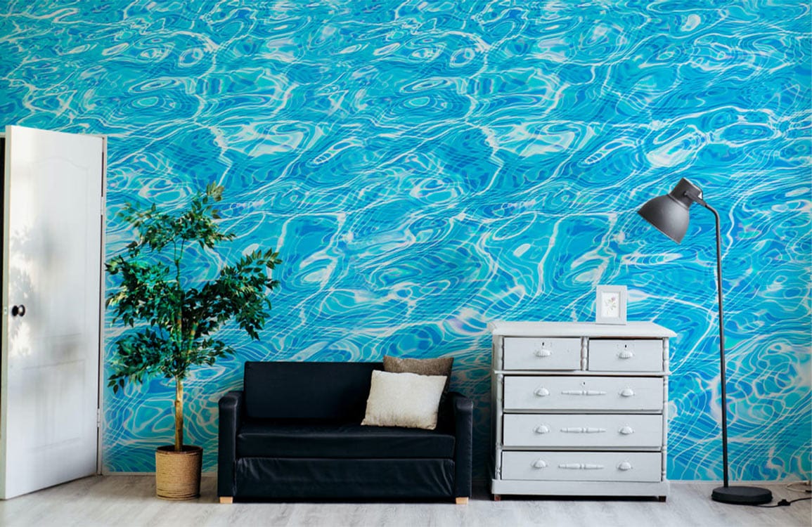 Vivid Aqua Blue Water Ripple Wallpaper in modern room; black sofa, white dresser, floor lamp, plant.