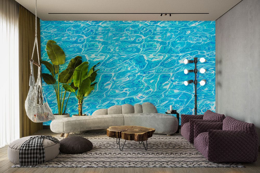Vivid aqua blue water ripple wallpaper, grey sofa, purple chairs, wooden floor in modern living room.