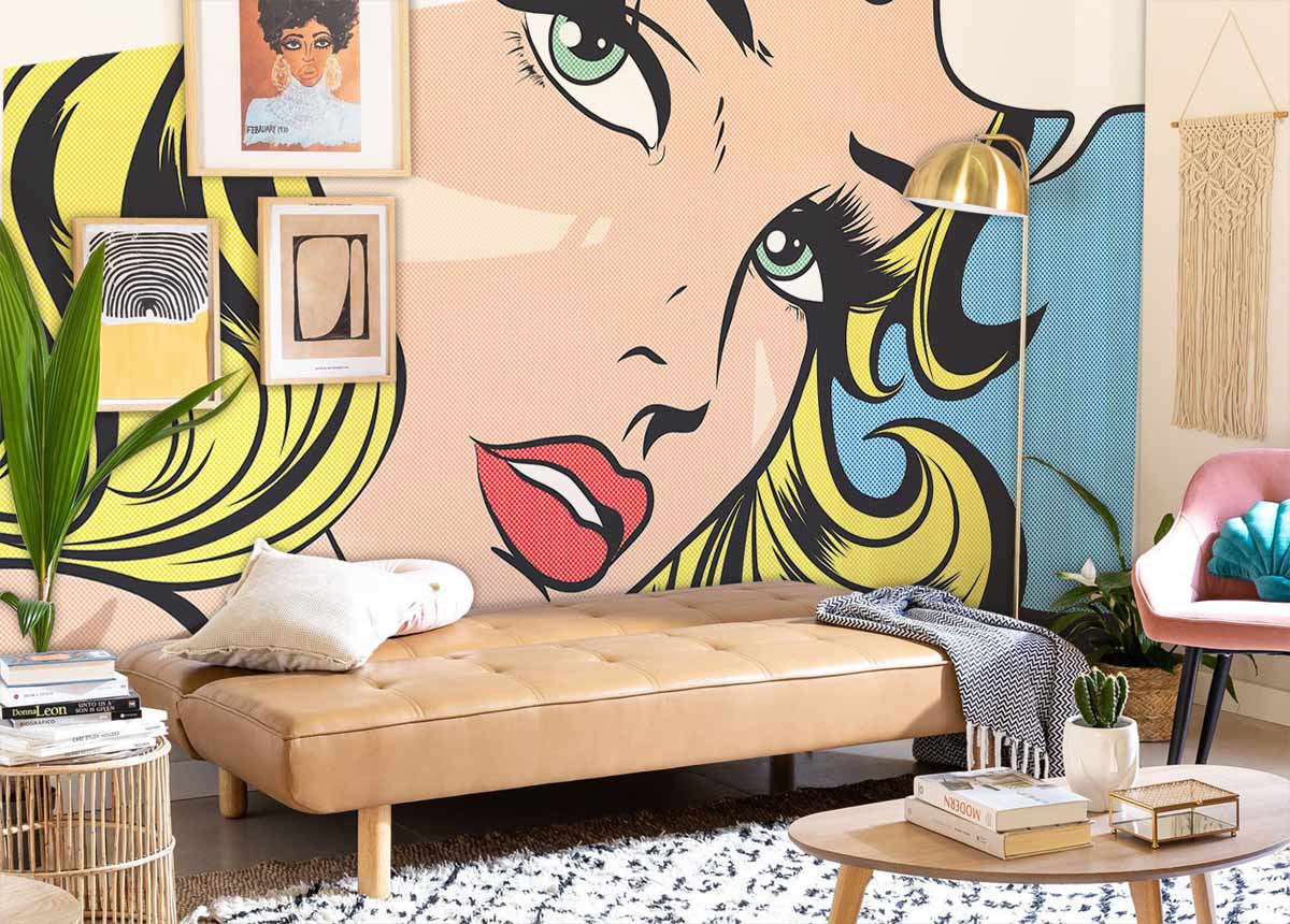 Retro Pop Art mural wallpaper, vibrant colours, tan sofa, pink chair, and chic living room decor.