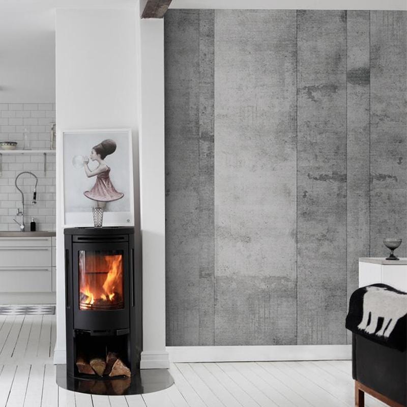 Industrial grey concrete wallpaper, modern living room, wood-burning stove, white floor, kitchen view.