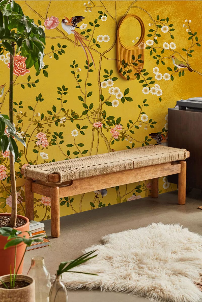 Golden Floral Garden Mural Wallpaper with birds, wood bench, lush yellow floral pattern, cosy rug.
