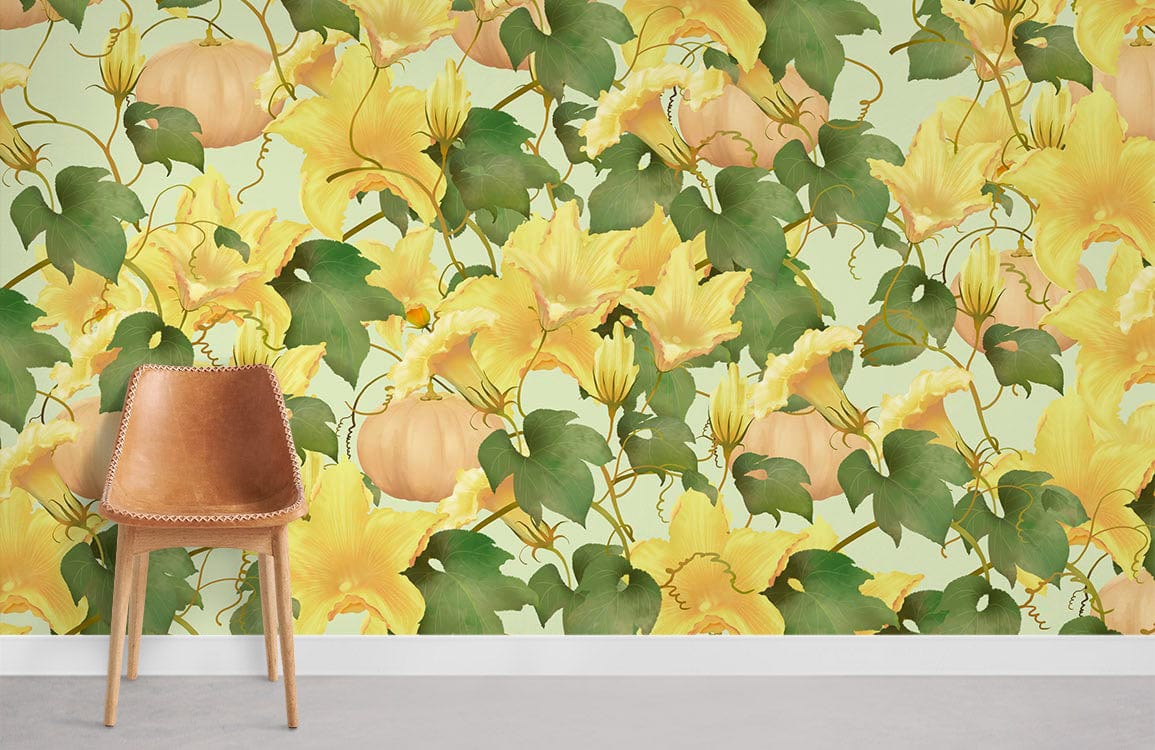 Leather chair beside Autumn Pumpkin Vine Floral Wallpaper in yellow-green with botanical design and grey floor.