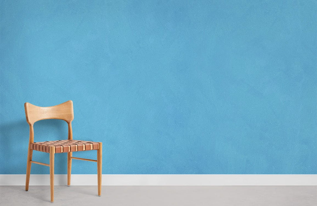 Elegant Sky Blue Textured Mural Wallpaper with wooden chair, grey flooring in modern interior design setting.