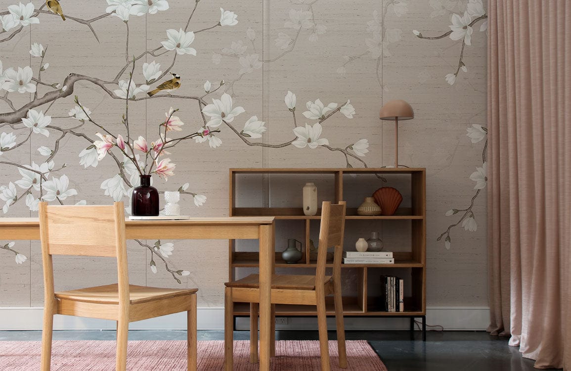 Elegant Blossom Beige Floral Mural Wallpaper with birds, wooden dining set, shelves, pink curtain, rug, lamp.