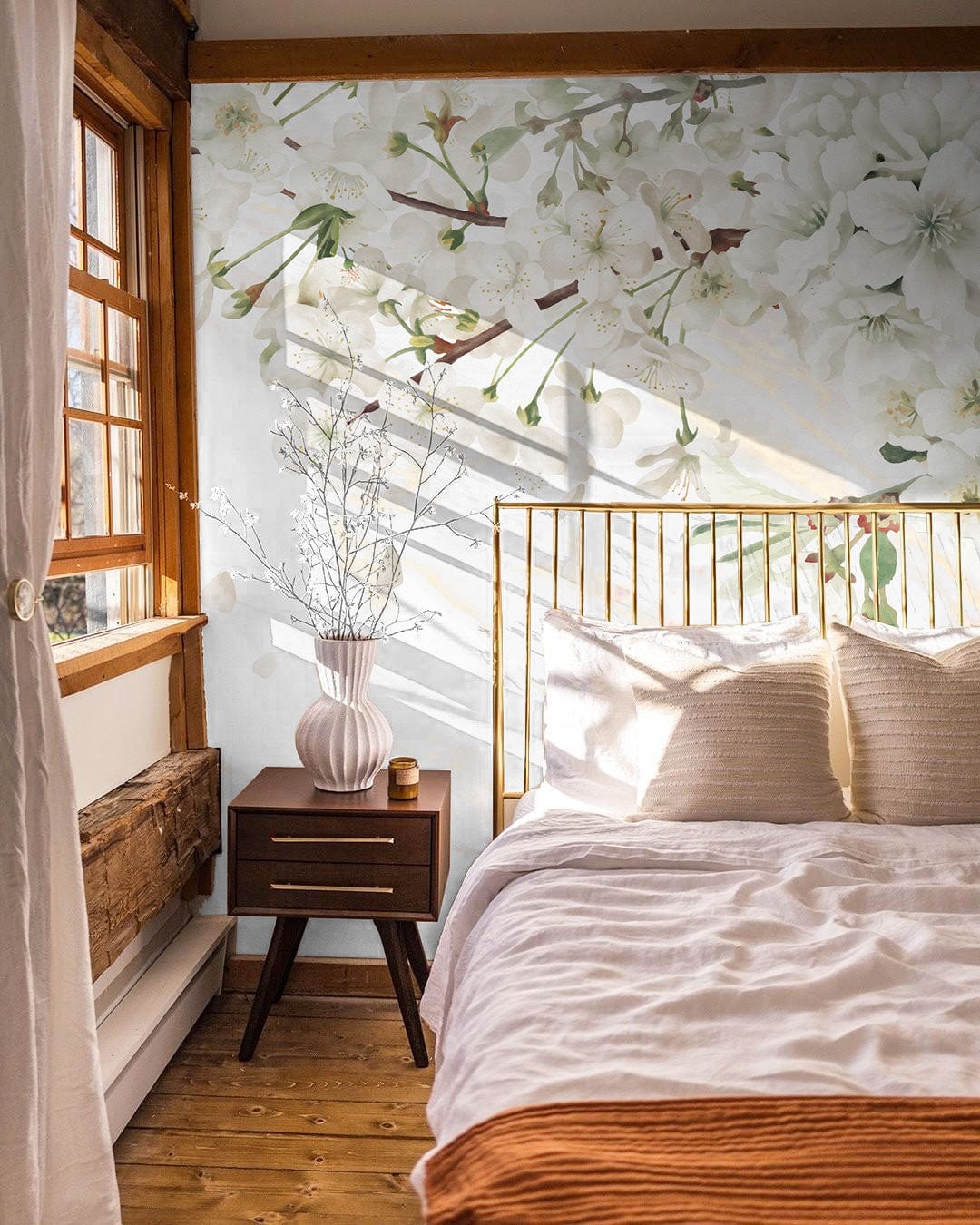 Elegant Blossom Garden Mural, bedroom decor, wooden flooring, gold bed frame, bedside table, floral wallpaper.