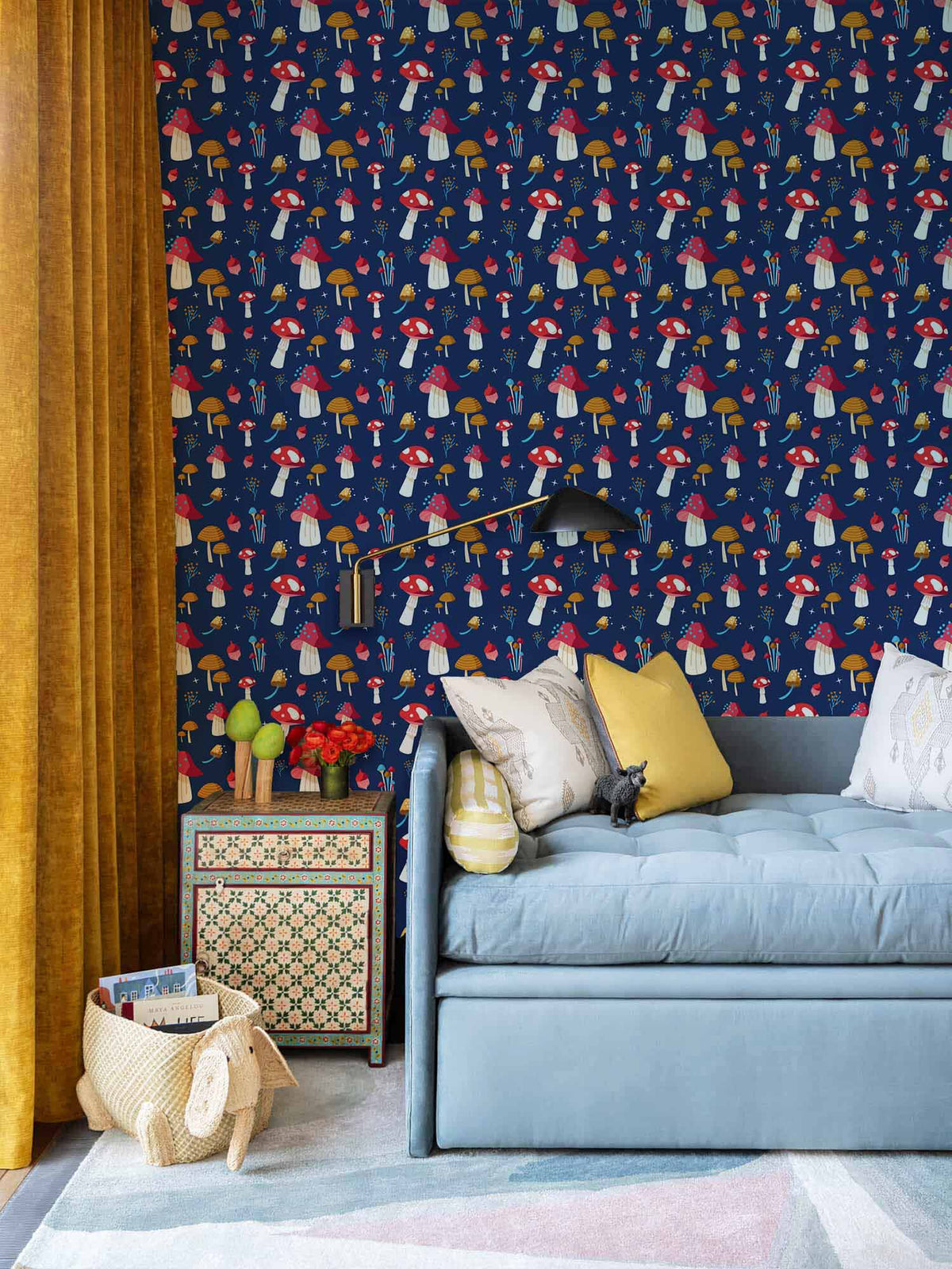 Whimsical Mushroom Wonderland navy wallpaper, blue sofa, mustard curtains, patterned side table, stylish living room.