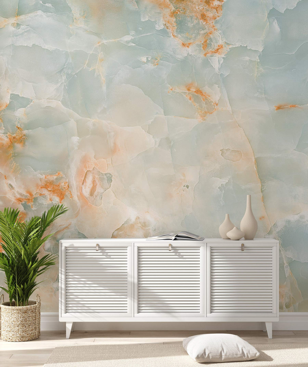 Elegant marble effect mural wallpaper with white cabinet, lush decor, enhancing modern living room aesthetics.