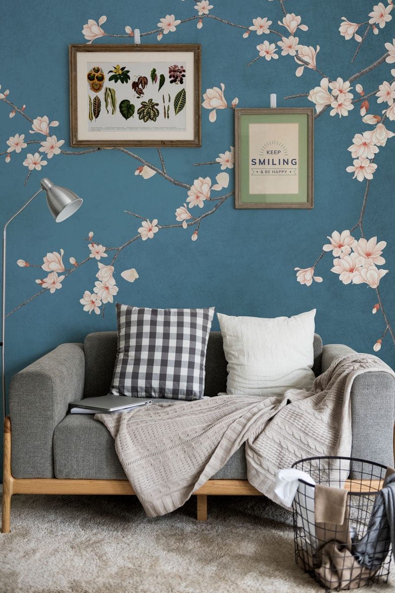 Elegant blue cherry blossom bird wallpaper, grey sofa, framed art, cosy living room decor.