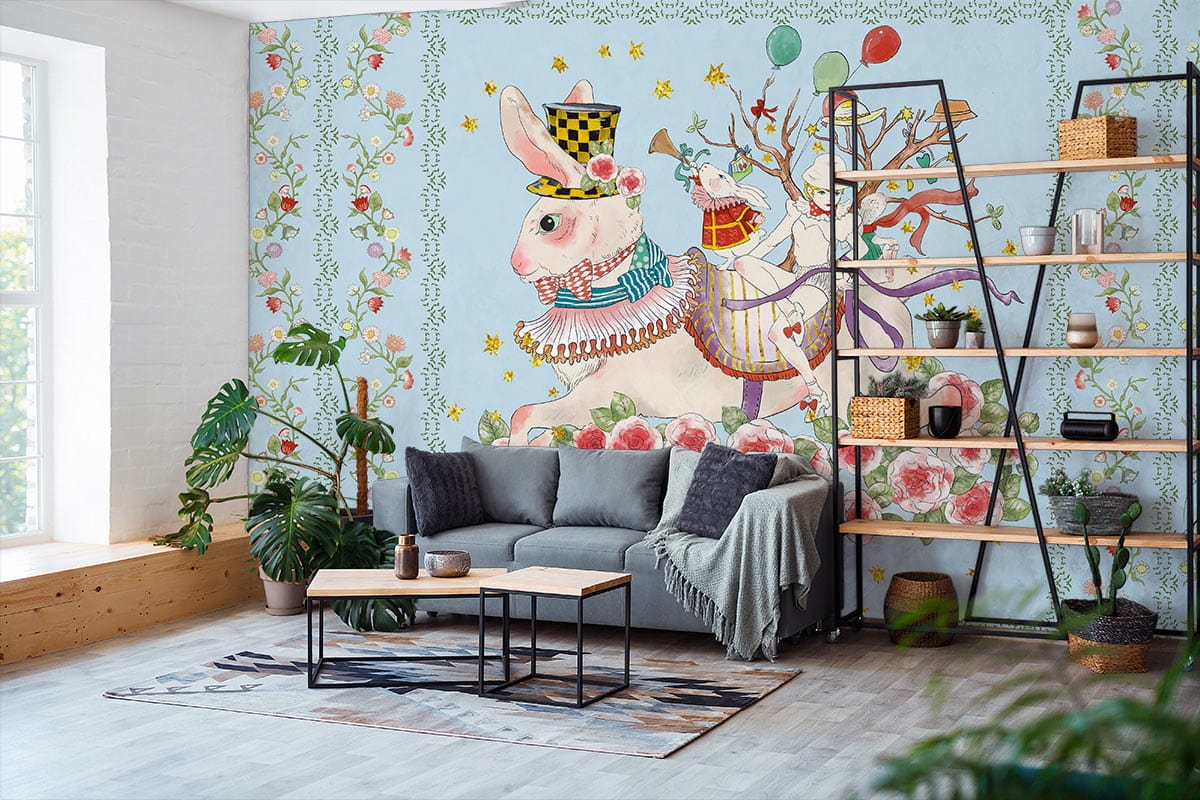 Whimsical pastel rabbit mural, grey sofa, wooden shelving; children's room with light wood flooring.