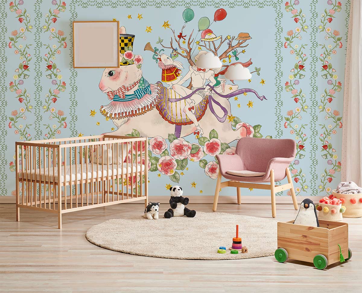 Whimsical pastel fantasy rabbit mural wallpaper in nursery with wooden cot, pink chair, light wood flooring.