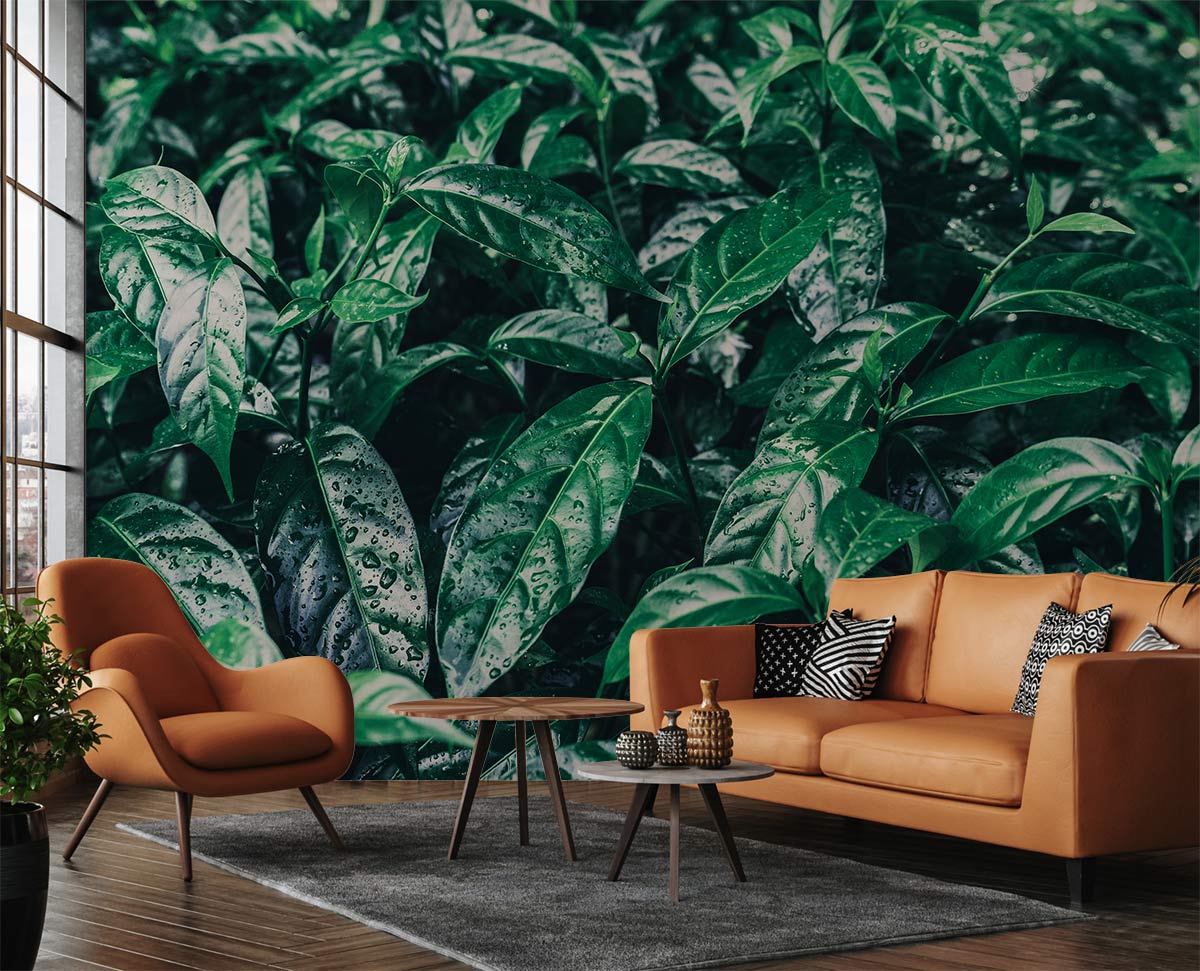 Luxurious green foliage wallpaper with tan modern sofa, armchair, in stylish living room setting.