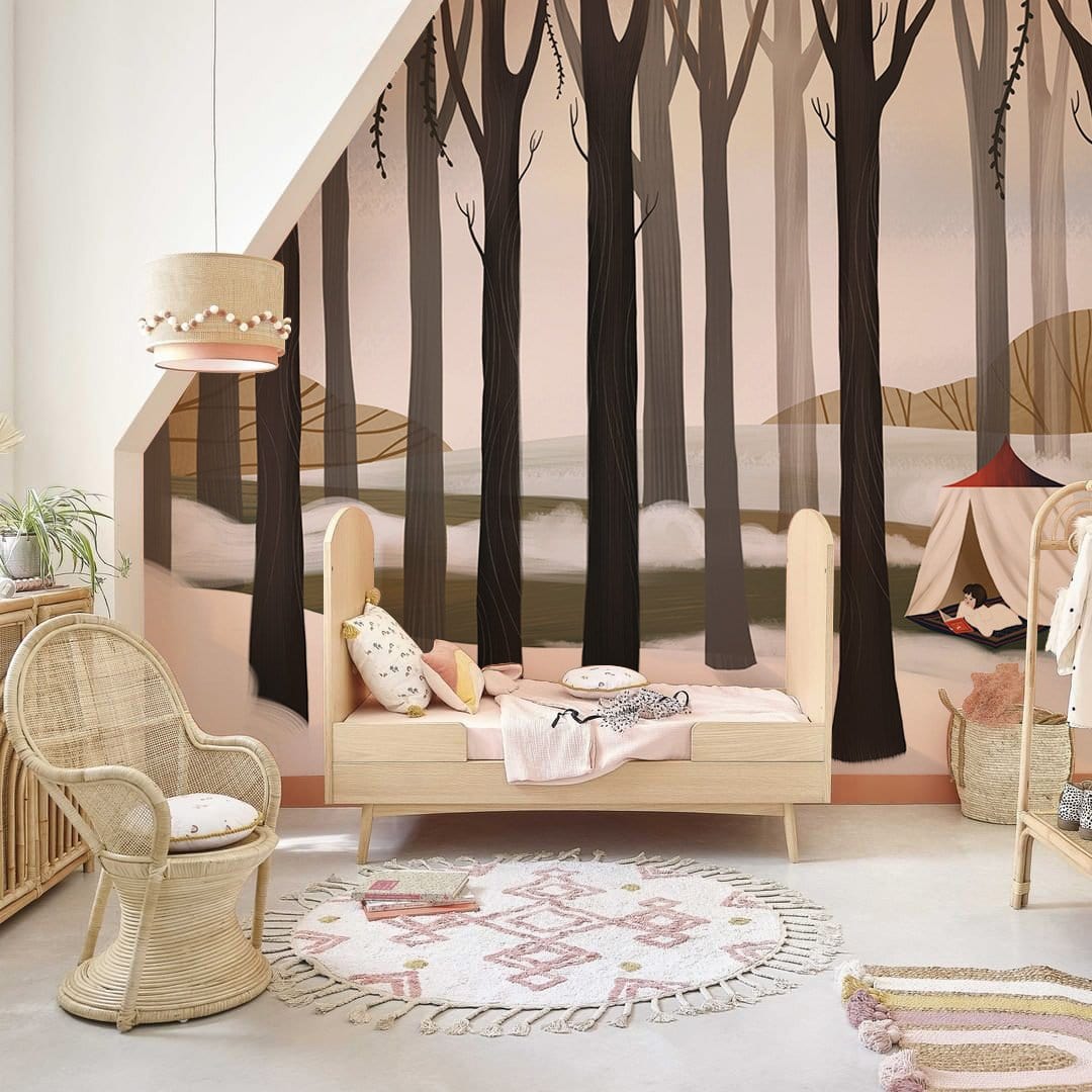Children's room featuring Winter Forest Retreat Mural Wallpaper, wicker chair, wooden bed, and round rug.