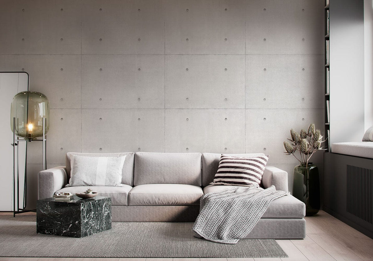 Industrial grey concrete wallpaper in modern living room, featuring grey sofa, marble table, neutral decor.