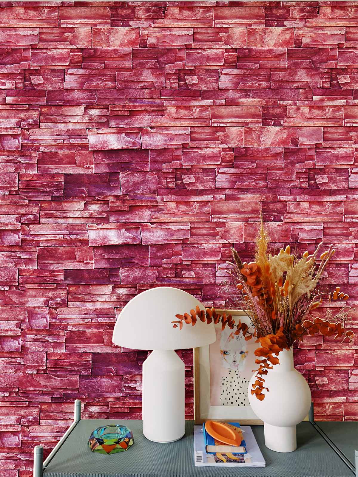 Rustic red brick wallpaper, vase and lamp on grey table, enhancing a modern urban interior design.