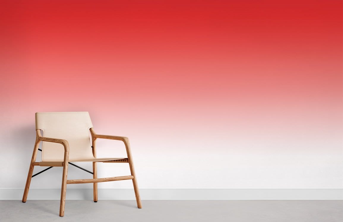 Vibrant red-to-white gradient ombre wallpaper with wooden chair on grey flooring in modern room.