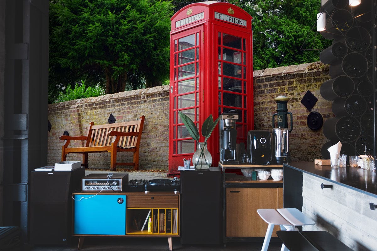 Classic red British telephone box mural wallpaper, vintage charm, urban kitchen setting, modern decor accents.