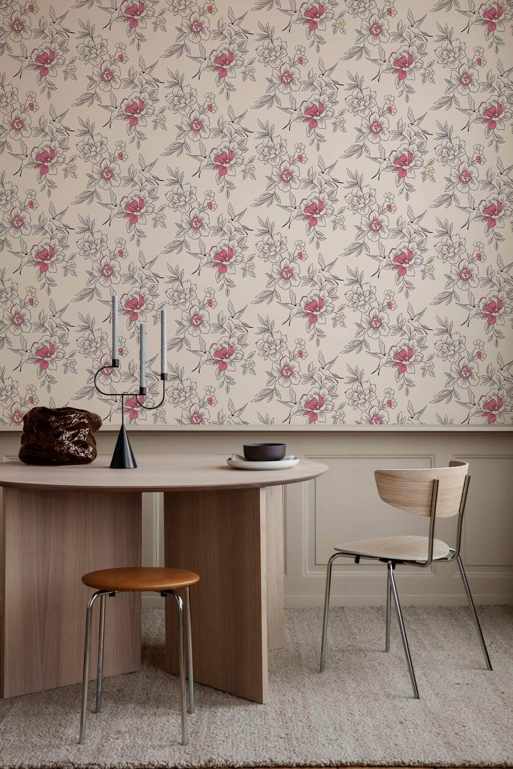 Vintage floral wallpaper in pink and white, wooden table, modern chair, beige carpet, elegant design.