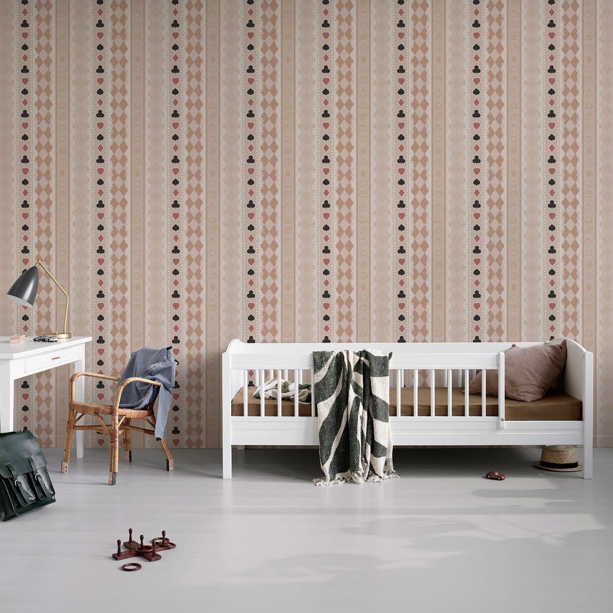 Vintage stripe wallpaper in beige and pink floral, white daybed, wooden chair, nursery room setting.