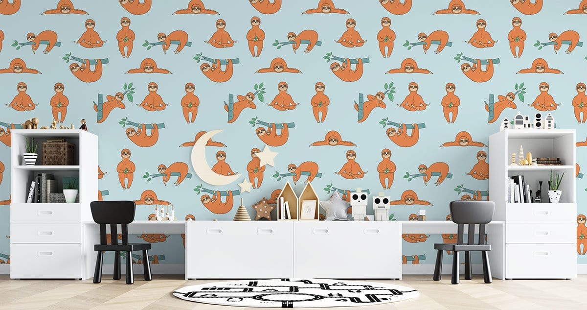 Playful sloth wallpaper on blue background, with modern white cabinets in children's room, black chairs.