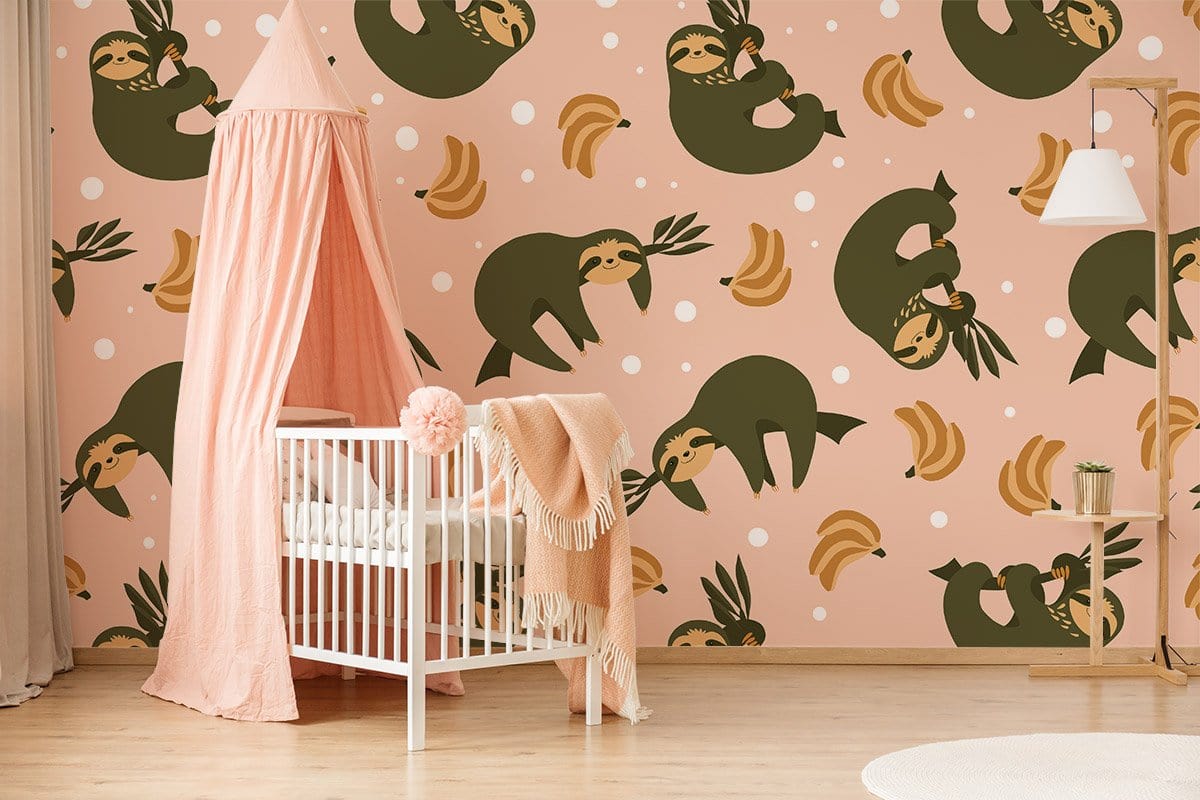 Playful sloth wallpaper in nursery room with white cot, pink canopy, light wooden flooring, and lamp.