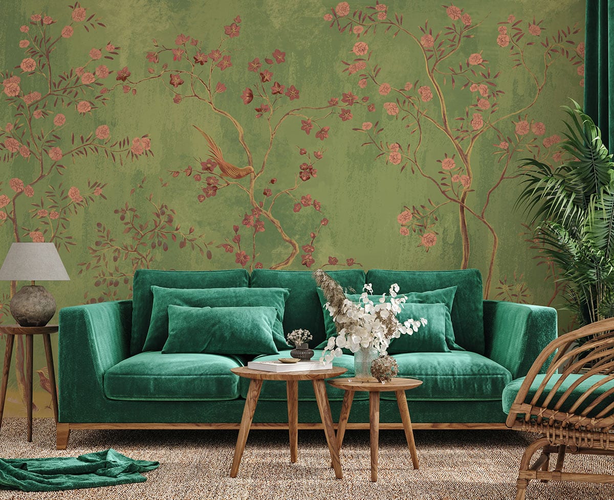 Elegant Green Chinoiserie Garden Wallpaper with birds; green velvet sofa, wooden tables, neutral flooring.