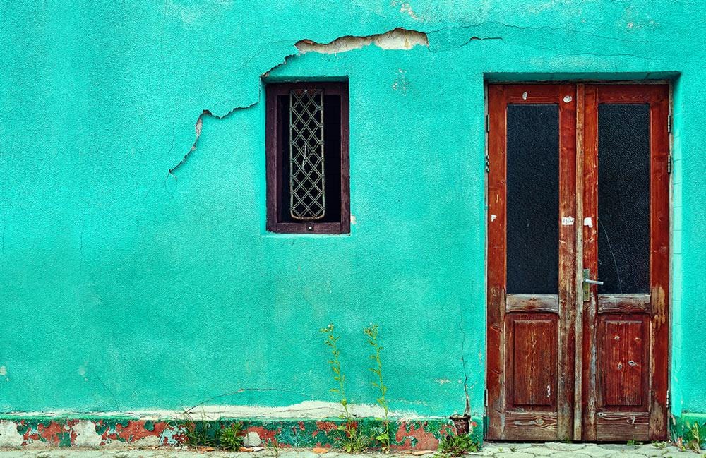 Vintage Teal Wall Mural with Rustic Wood Door Accents Design
