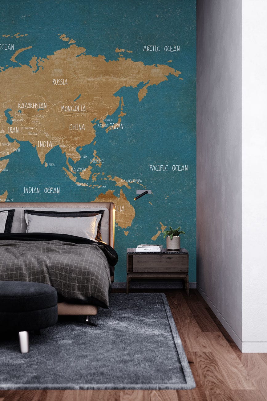 Vintage world map mural wallpaper, blue and tan, grey rug, modern bedroom with wooden flooring.
