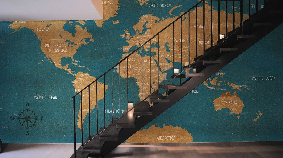 Vintage Blue and Tan World Map Mural Wallpaper, elegant staircase, modern flooring in stylish setting.