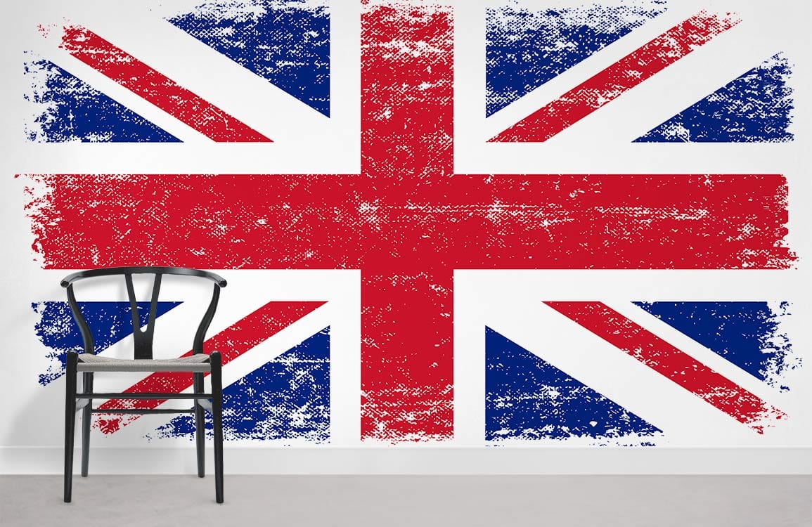 Vintage Union Jack wallpaper with distressed design, black chair, white wall, grey flooring.