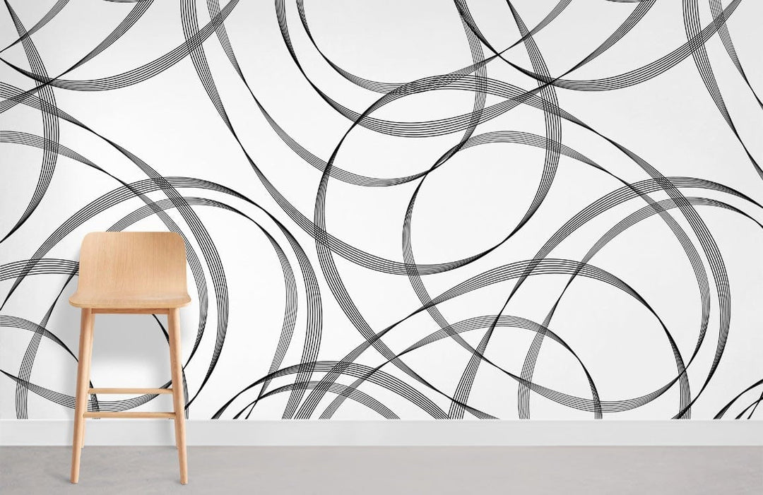 Monochrome swirl wallpaper with wooden chair on grey flooring in modern interior design setting.