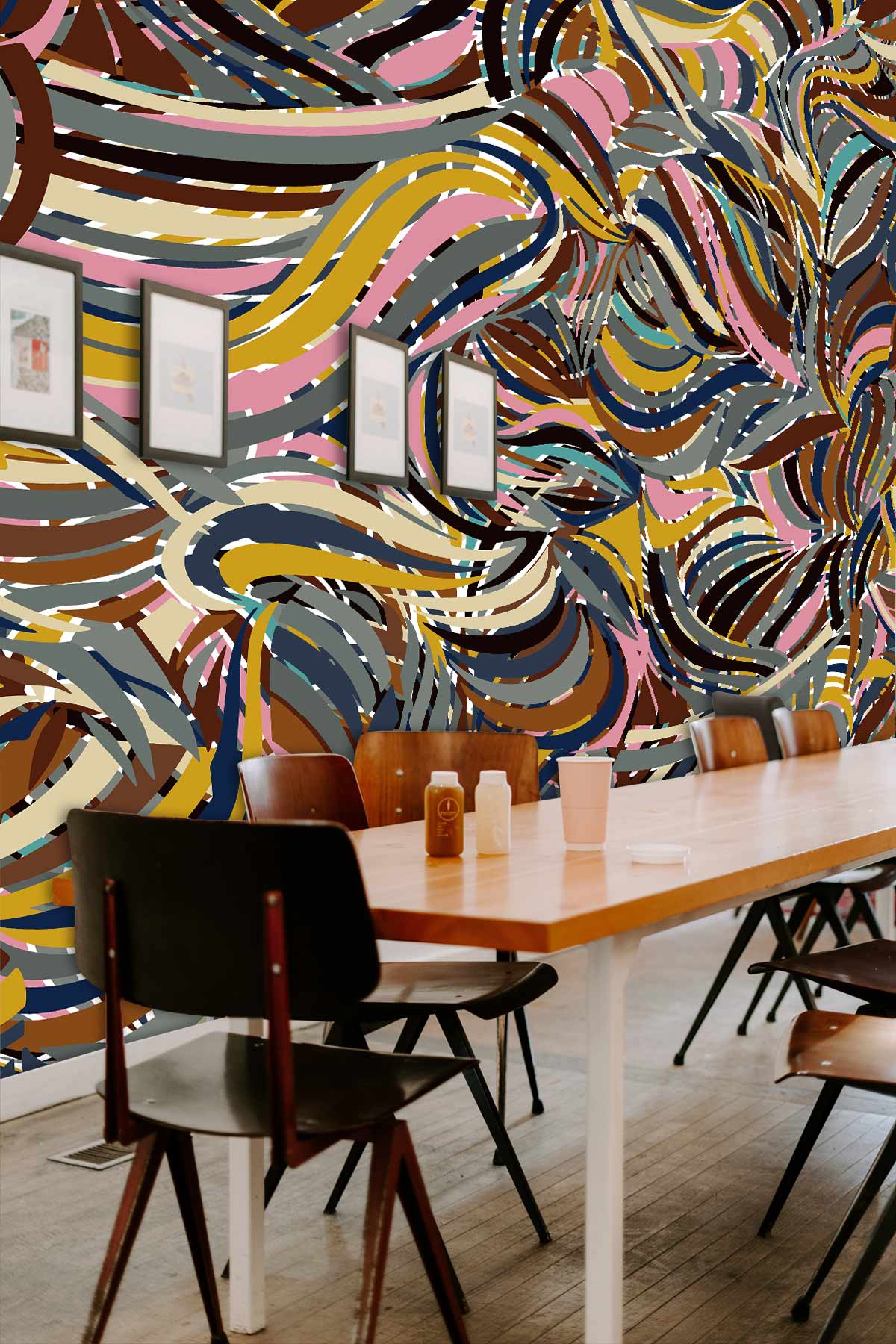 Abstract swirl multicolour retro wallpaper in dining room with wooden table, chairs, and framed art.