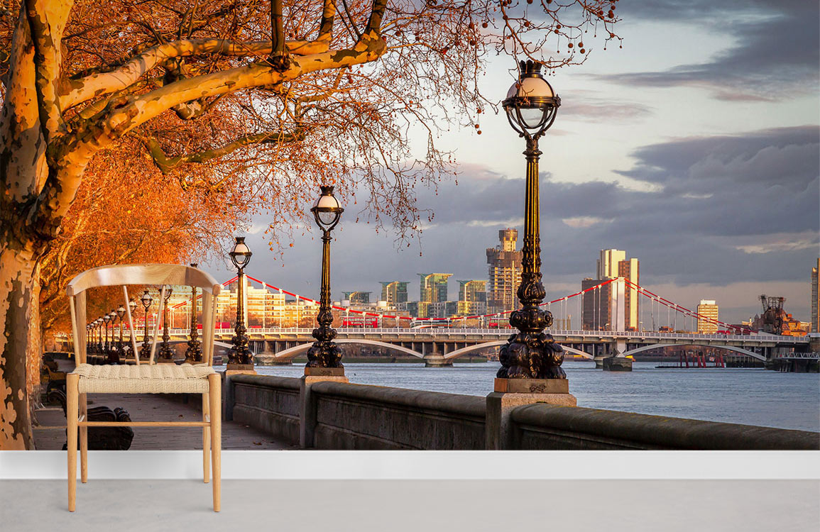 Golden hour Thames mural wallpaper with chair, showcasing scenic London view, enhancing room aesthetic.