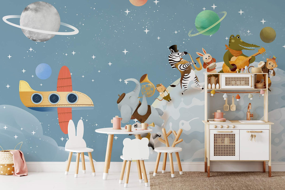 Children's blue space safari animal mural wallpaper in playroom with white chairs, toy kitchen, hardwood floor.