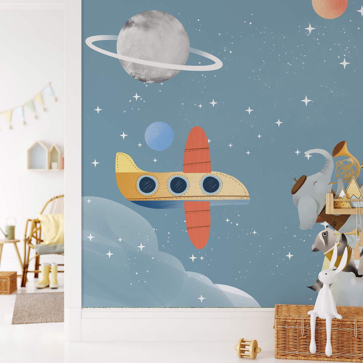 Children's room with Whimsical Space Safari blue mural wallpaper, featuring animals and planets, wooden toys.