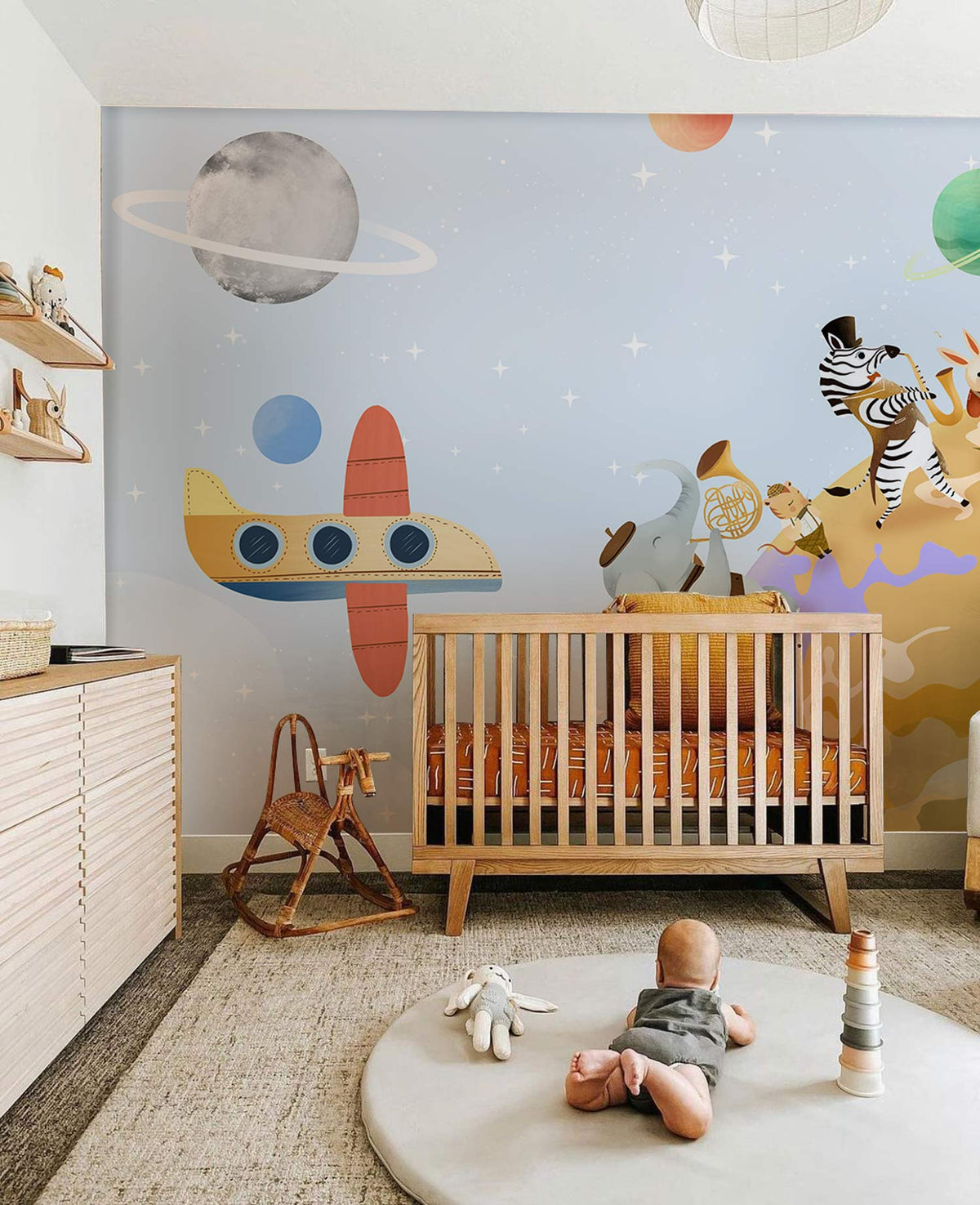 Children's room with Whimsical Animal Adventure Space Mural Wallpaper, wooden cot, and grey carpet.